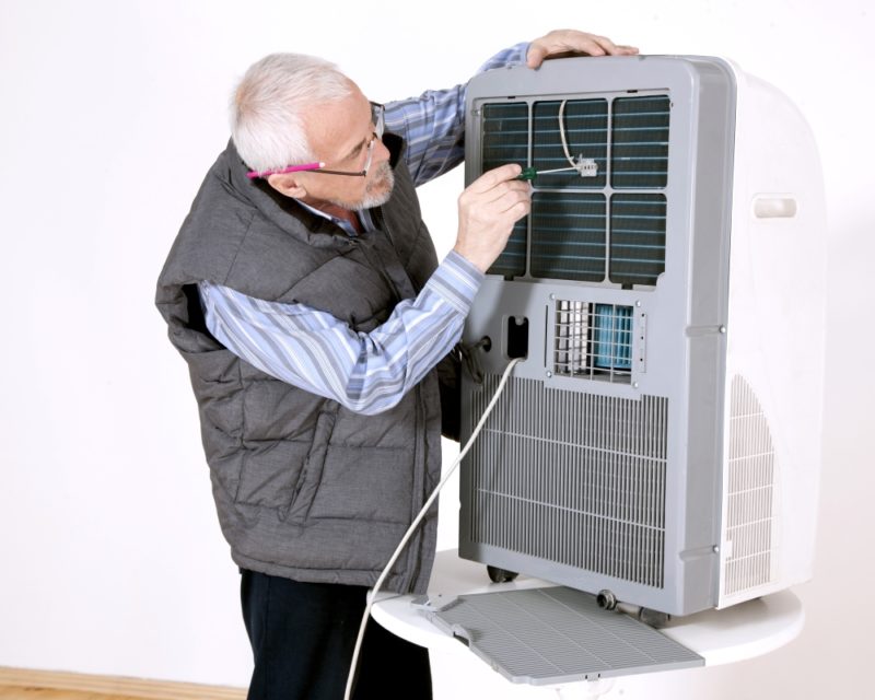 Elderly man attempting DIY repair