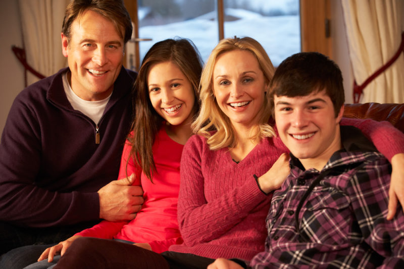 happy family sitting on sofa