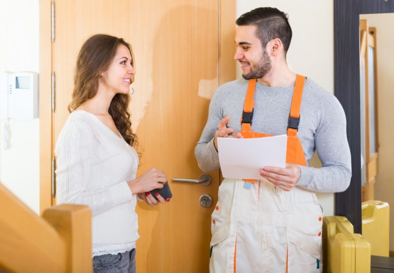 woman talking to HVAC technician