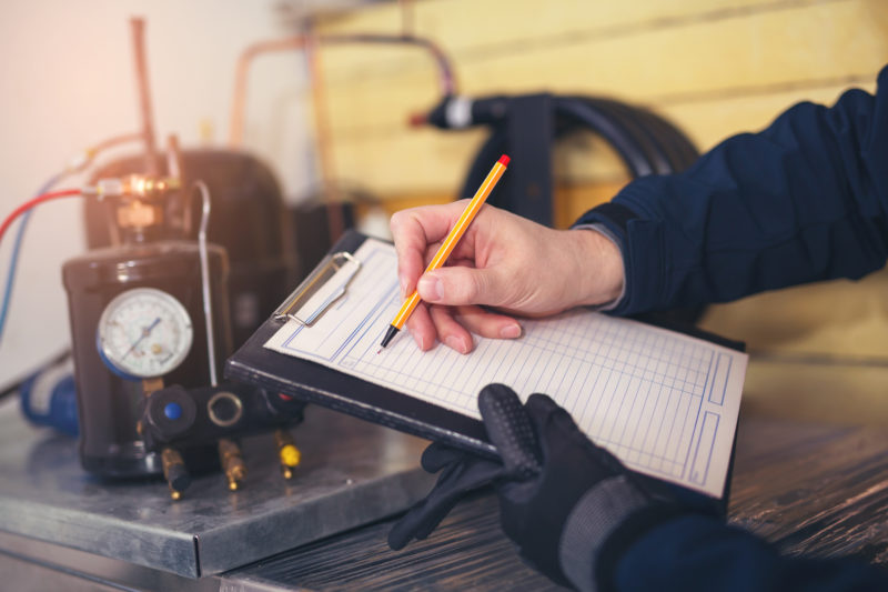 technician going over hvac system maintenance checklist