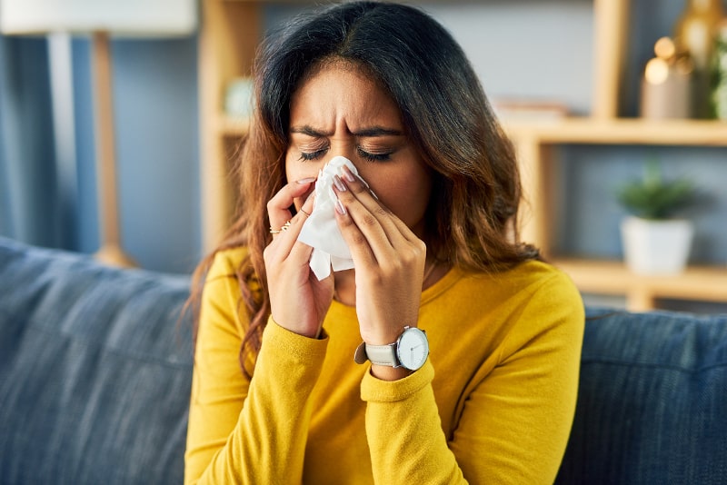 woman blowing her nose