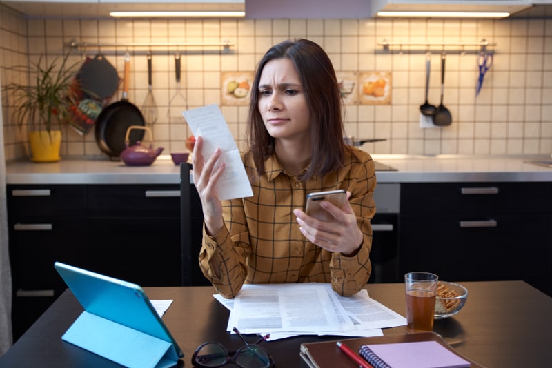 Woman Frowning Figuring Out Bills