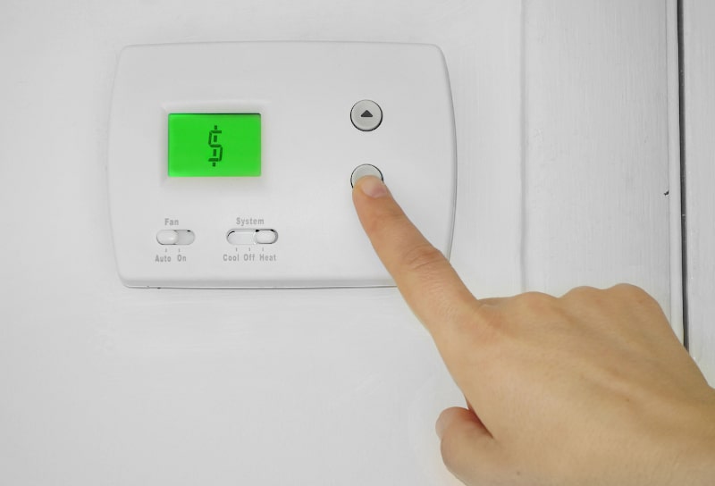 person trying to set a malfunctioning thermostat