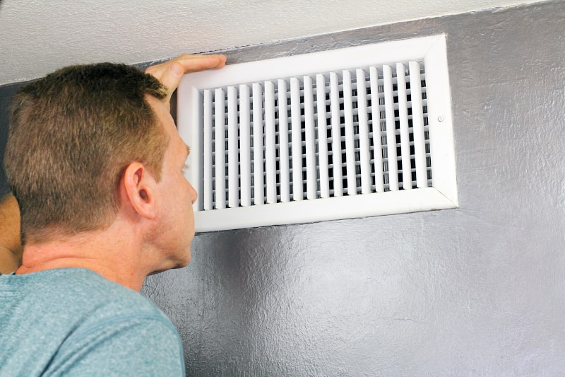 Man Checking Air Vent